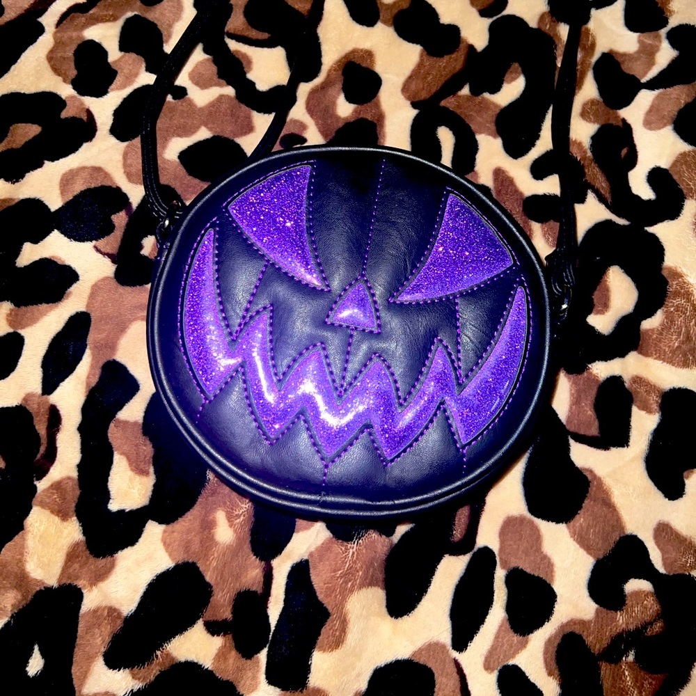 Small Pumpkin Kult crossbody bag! Matte black with purple glitter detailing.